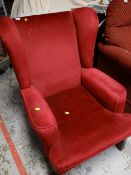A red velour wingback armchair together with a Chesterfield-style armchair (distressed)