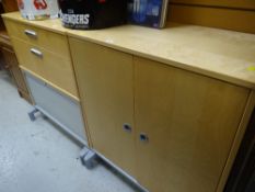 Two modern lightwood office storage cabinets