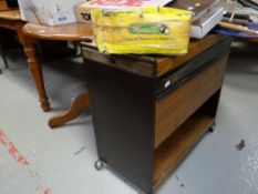A polished wood circular dining table together with a hostess trolley