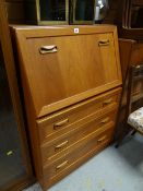 A drop front G-Plan style teak bureau above three drawers