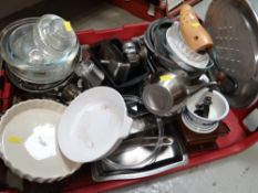 A crate of kitchenware largely stainless steel items together with a coffee grinder