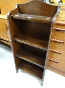 A compact narrow oak bookcase