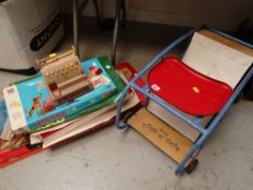 A Triang Rock & Roll baby walker together with several boxed games & a child's cash register