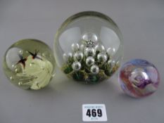 Three vintage glass paperweights by Caithness etc