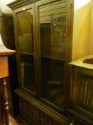 Dark wood display cabinet with two upper glazed doors over two base drawers by Younger Furniture