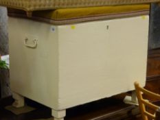 White painted wooden box with metal handles and upholstered top