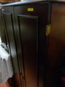 Modern dark wood cupboard with pull-out shelves