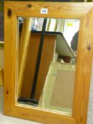 Abstract painting on material and a pine framed wall mirror