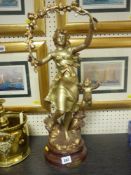 Heavy metallic figure on a wooden base of 'Les Roses, Par Kossowaki'