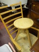Ladderback light wood rocking chair and a rise and fall light wood stool
