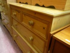 Pine chest of two long and two short drawers and a pine headboard