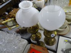 Two brass effect lamps and a school type bell