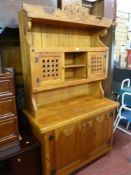 Pine dresser with carved floral detail, vented doors to upper section and two door cupboard base