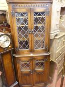 Priory style corner cupboard with twin leaded and glazed upper doors and base doors
