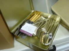 Tin containing parcel of mixed cutlery