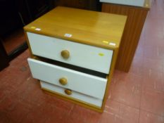 Modern light narrow chest of three painted white drawers