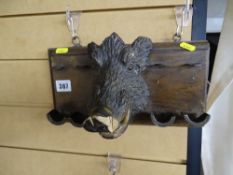 Carved boar's head pipe rack