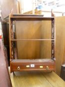 Small three shelf wall hanging bookshelf with base drawer