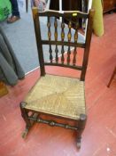 Polished wood rocking chair with rush seat and spindleback