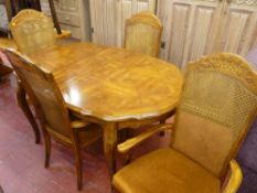 Modern extending dining table and four Bergere back chairs