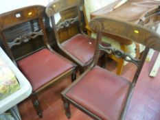 Three Regency mahogany dining chairs with carved centre rail and drop-in upholstered seats