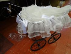 Metal based wicker doll's pram with silk covers