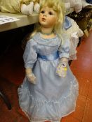 Doll with long light blue silk dress and blonde hair