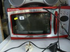 Red Russell Hobbs microwave oven and an anglepoise lamp E/T
