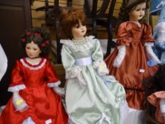 Three dolls - curly rose adorned hair with long red dress; lime green dress with undergarment and