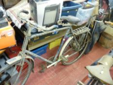 Vintage bicycle with a bag of vintage golf clubs