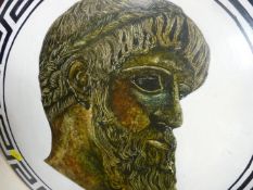 Ornamental metal warrior's shield with image of a Greek man
