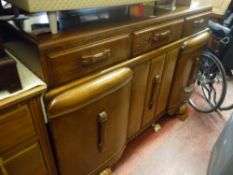 Oak railback sideboard with carved centre drawer over three door base