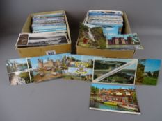 Two boxes containing a large quantity of vintage postcards
