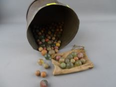 Tin containing a quantity of vintage marbles