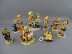 Seven Goebel/Hummel figurines and a composite figure of two Japanese ladies