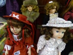Four dolls - red dress, curled hair and bonnet; burgundy dress with fur and bonnet; Scottish