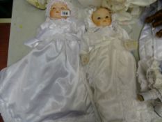 ALL DOLLS PORCELAIN HEADED UNLESS OTHERWISE STATED Two dolls in white silk dresses and bonnets