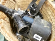 Two weaved baskets containing a quantity of vintage camera and photographic equipment