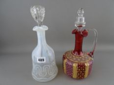 Opaline glass decanter with non-associated stopper and a cranberry and gilt decorated decanter