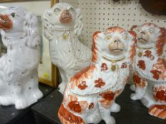 Pair of brown and white Staffs dogs with separate front legs and another pair of Staffs dogs