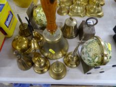 Collection of brass bells, pair of globe bookends and a vintage brass weight