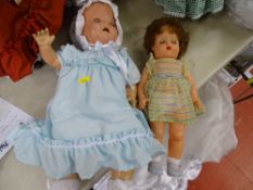 Composition headed doll (damage) in a blue dress and a rubber faced and rubber bodied doll