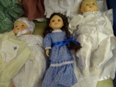 Three dolls - white silk dress and bonnet; doll with hair plaits and long blue dress and a little