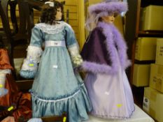 Two tall dolls, one in light blue long dress with bouquet of roses and curls and the other with