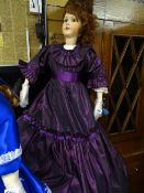 Very large doll with red hair and long purple dress