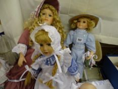 Three dolls - pink dress with bonnet and long curly hair; maid's outfit with bonnet and light blue