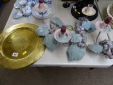 Four brass serving plates and a metal grapevine candelabra and candlestick