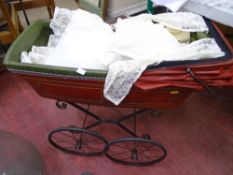 Metal hooded doll's pram with red decorated faux leather body and cream covers