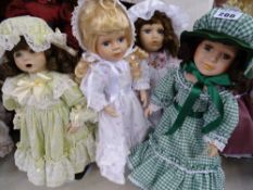 Four dolls - green check dress and bonnet; lime green dress with roses and bonnet and two in young
