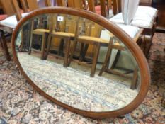 AN OVAL INLAID MAHOGANY WALL MIRROR, 98 x 63.5 cms